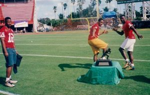 Tony Veland (left) waiting to pose with the Heisman Trophy pre-Orange Bowl
