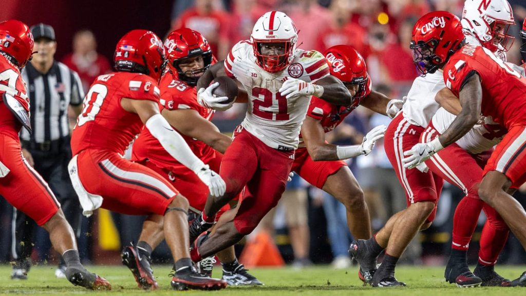 Emmett Johnson runs for a short gain against Cincinnati, Aug. 28, 2025